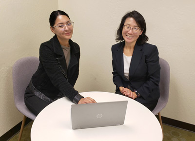 city office worker with intern and laptop
